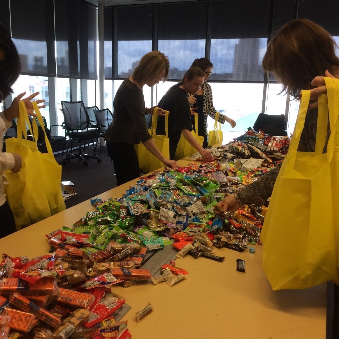 people filling bags with snacks for kids